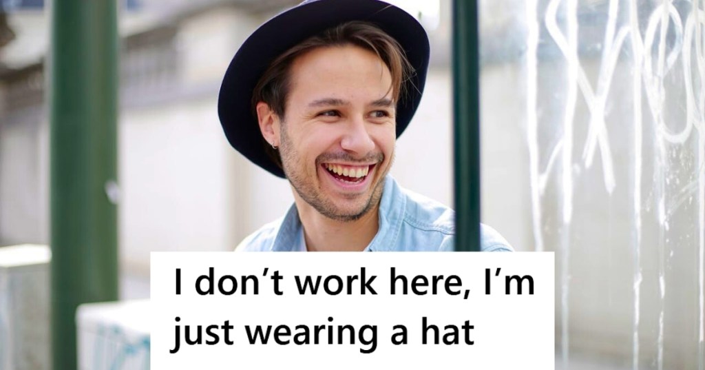 Smiling man wearing fedora hat outside