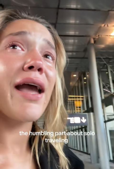Woman crying at Paris airport