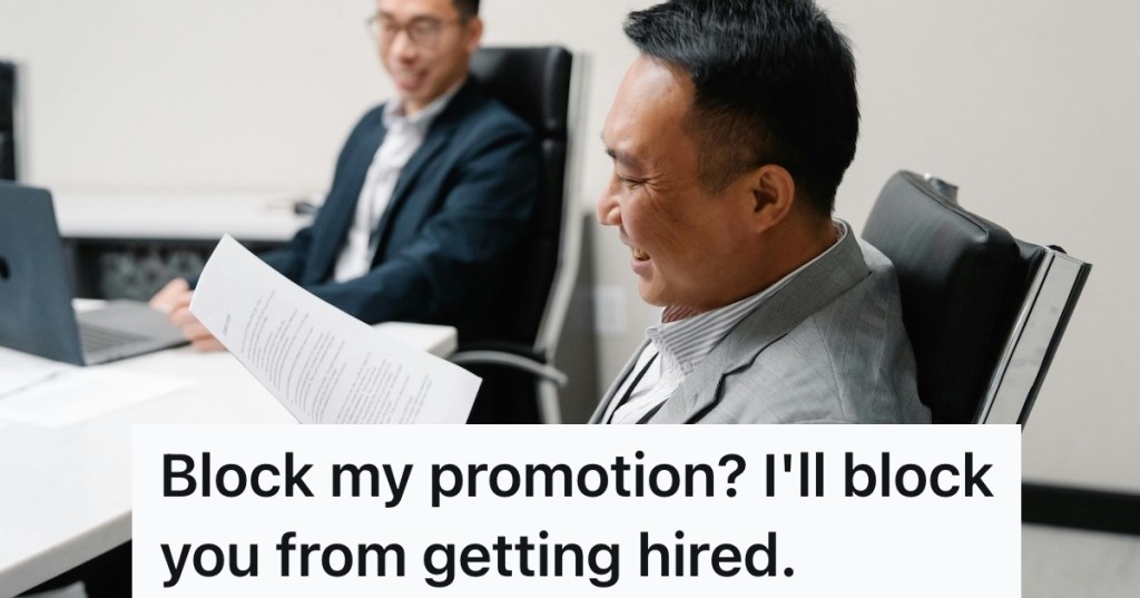 Man smiling while looking at papers in an office