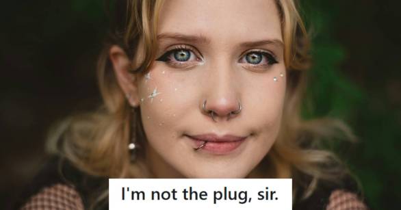 Blonde woman with at least six piercings in her face, smiling