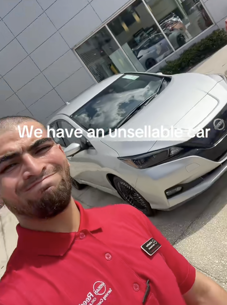 man at a car dealership