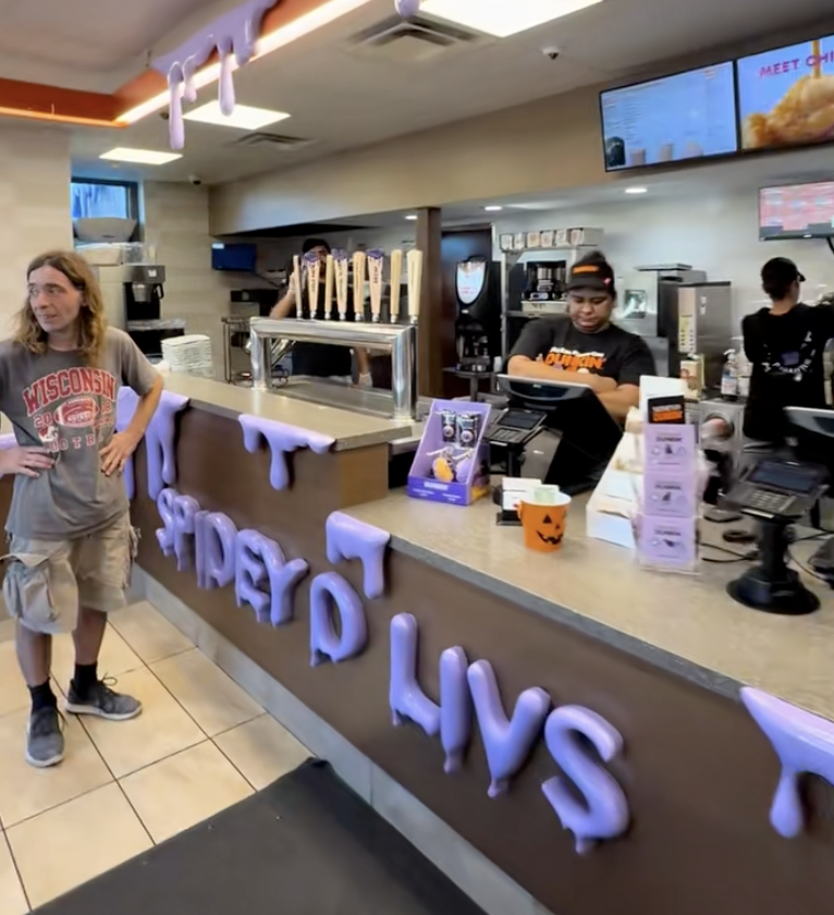 man in a dunkin' donuts store