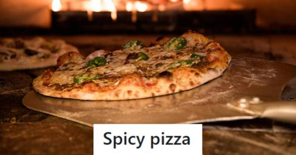 Pizza topped with cheese, pepperoni, and jalapeno going into the oven