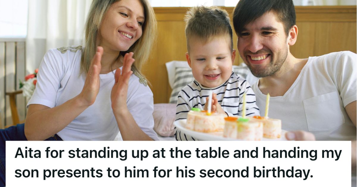 Man, woman and child smiling and looking at cupcakes