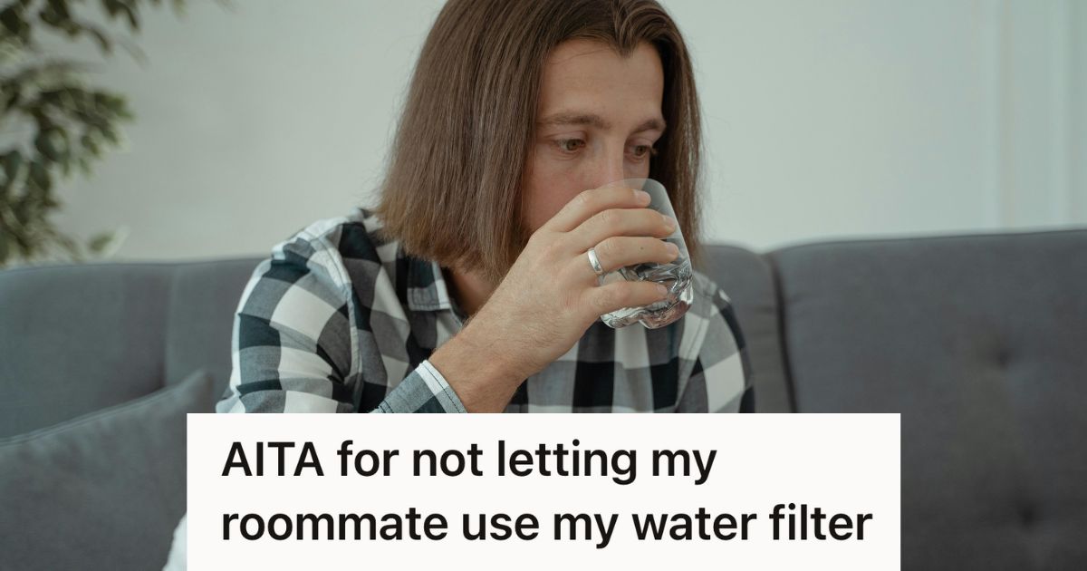 Young man drinking a glass of water
