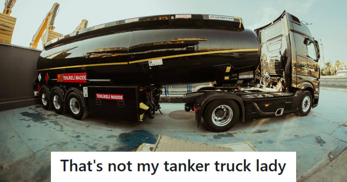 Black tanker truck parked outside of a gas station