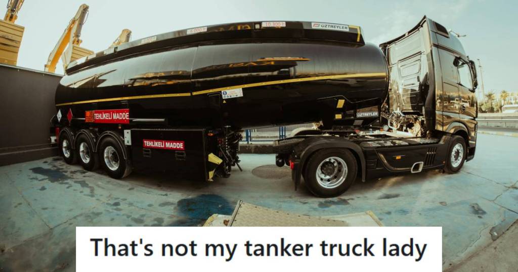 Black tanker truck parked outside of a gas station