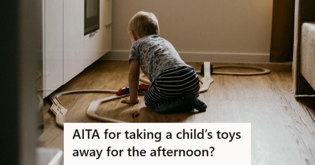 Young boy playing with his trains on the hard floor