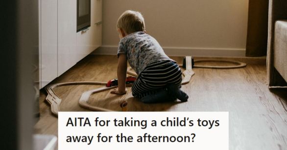 Young boy playing with his trains on the hard floor