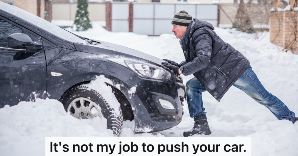 man pushing car in the snow