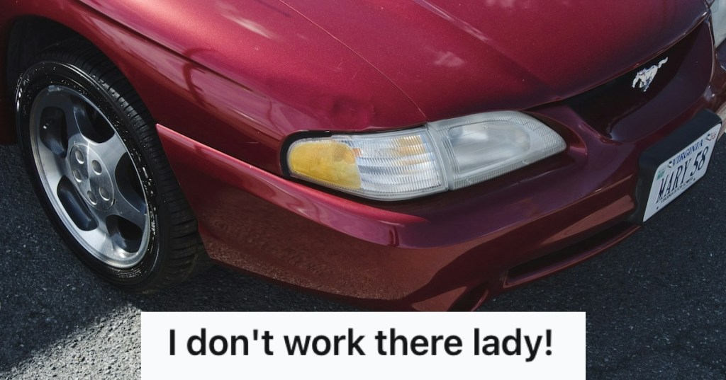 A maroon car with minor dent