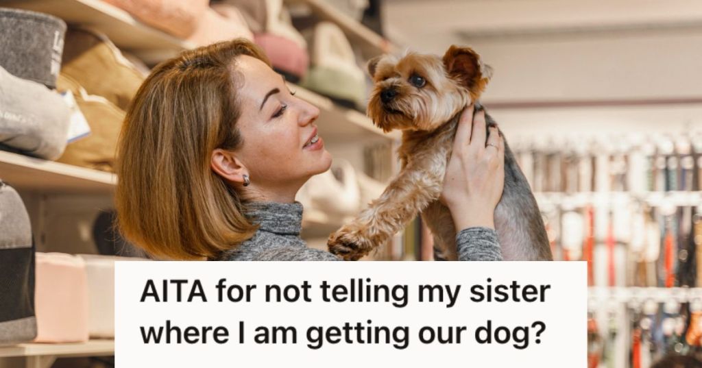 Woman holding up a dog and smiling