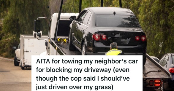 car being hooked onto tow truck's flatbed