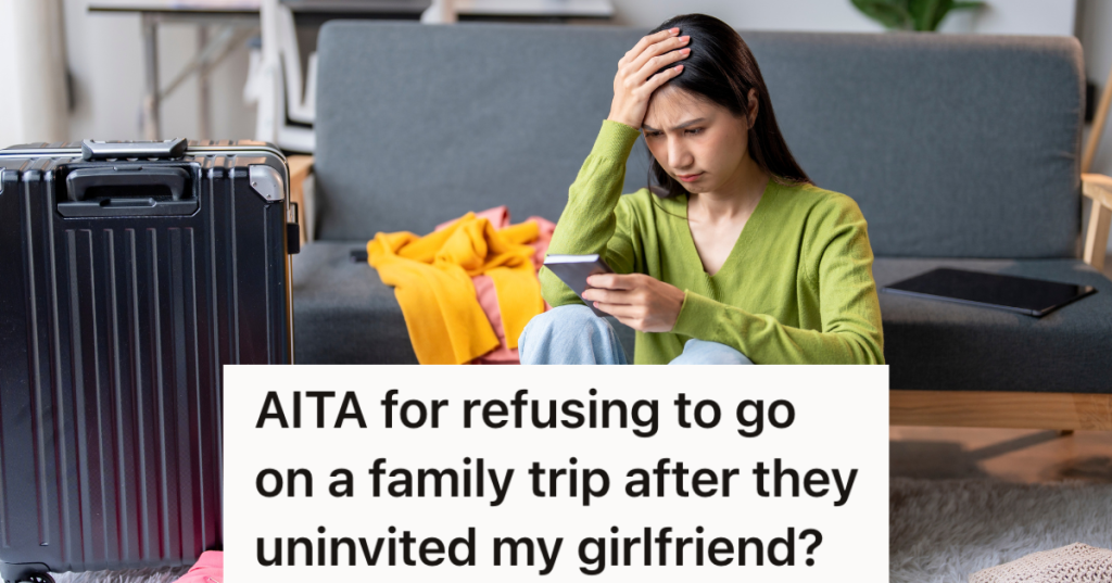 upset woman sitting next to a suitcase looking at her phone