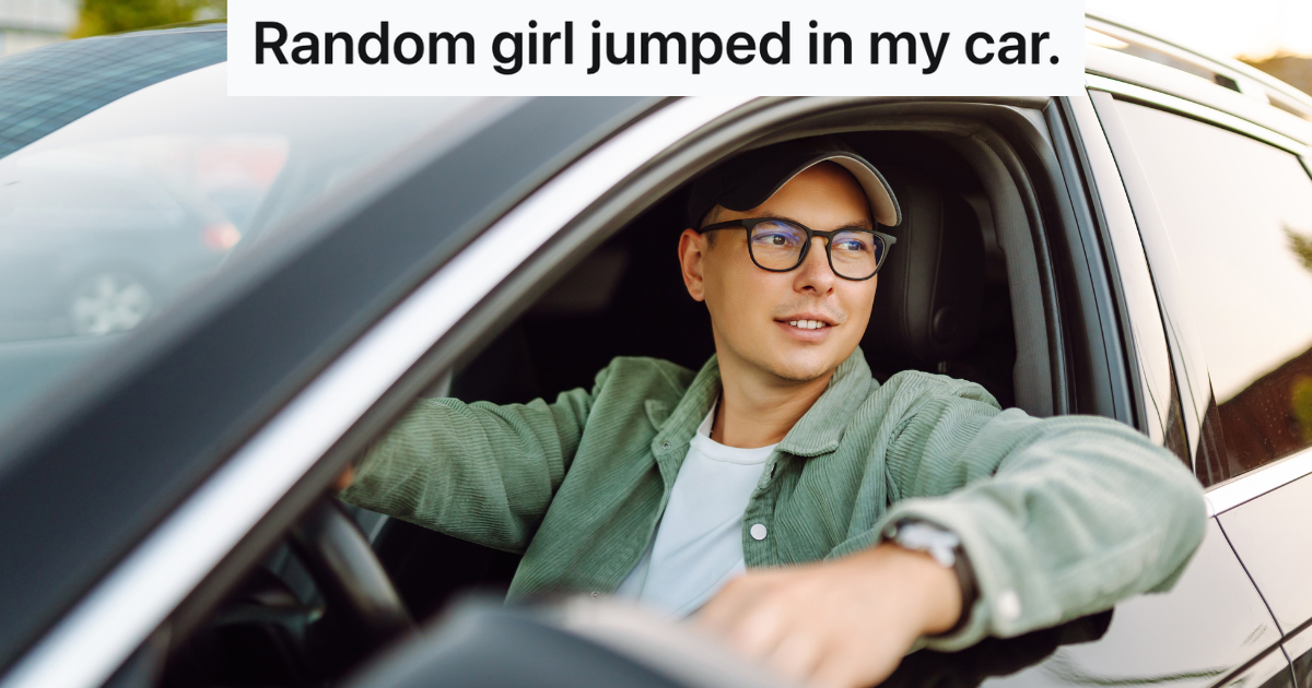 man sitting in the drivers seat of a black car