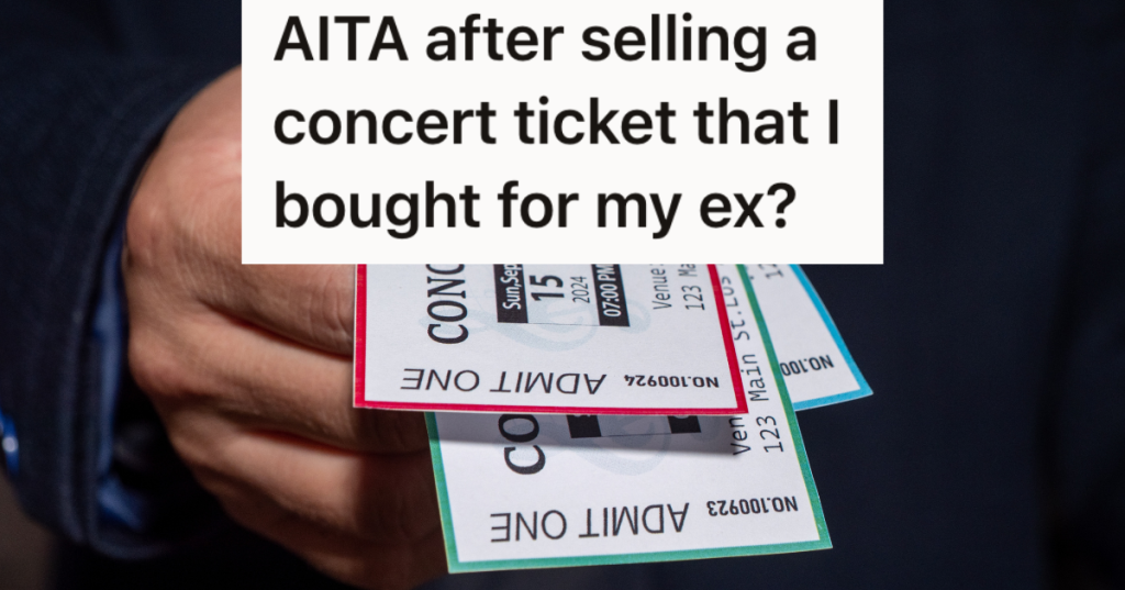 closeup of man's hand holding concert tickets