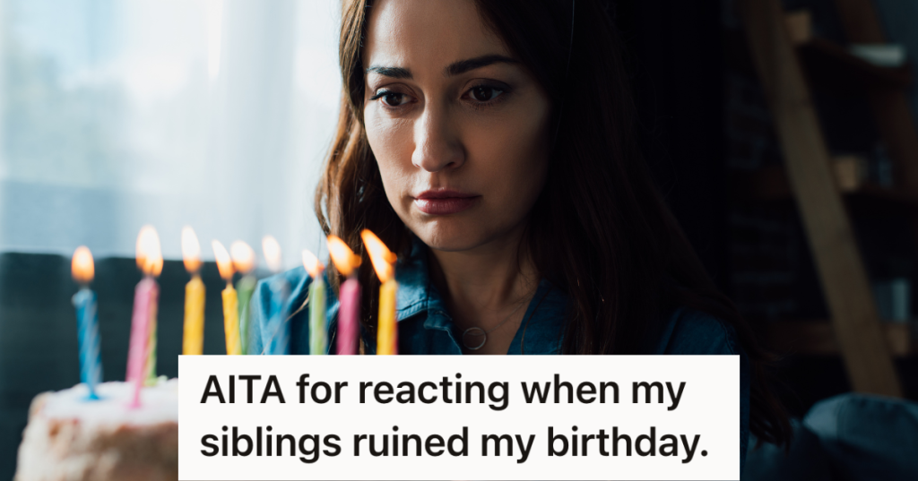sad woman looking at candles on birthday cake