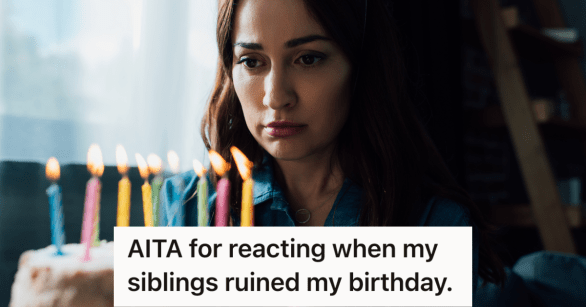 sad woman looking at candles on birthday cake