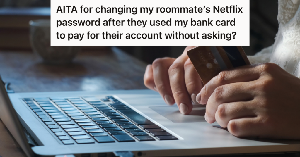 closeup of man's hands holding debit card and typing on laptop