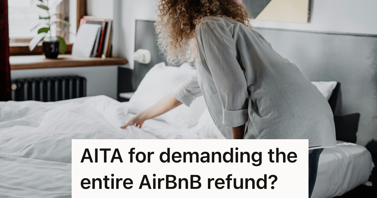 Woman standing next to a bed looking under bed covers