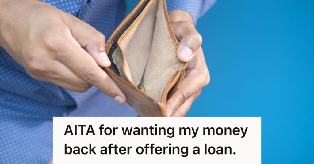 man holding up an empty wallet