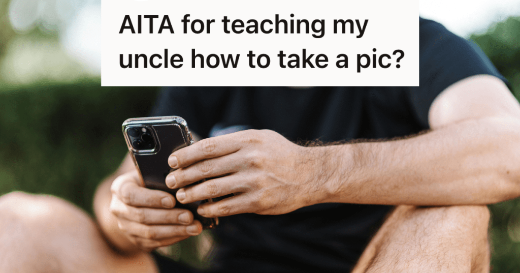 man in black shirt holding his iphone