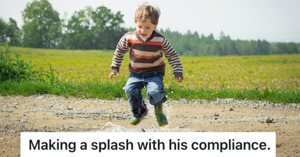 little boy jumping in puddle