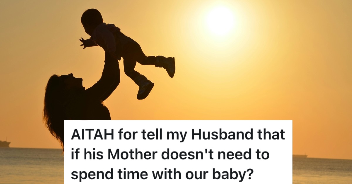 woman holding a baby up against the sunset