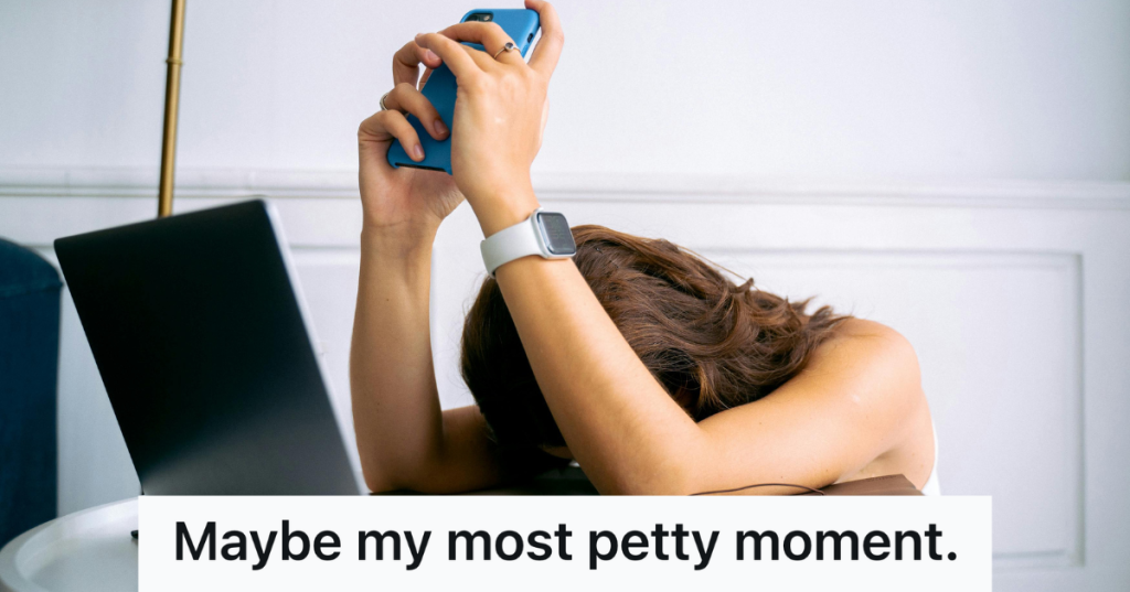 woman with head down holding up smartphone