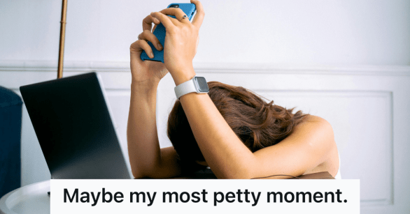 woman with head down holding up smartphone