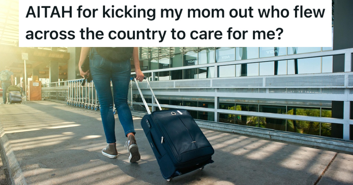 A woman in an airport pulling a suitcase
