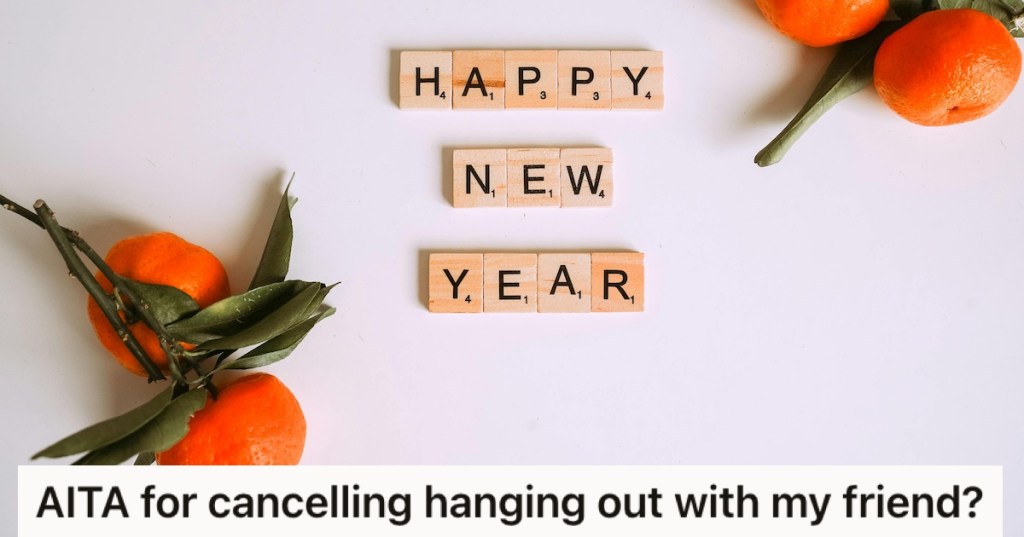 Scrabble tiles spelling 'Happy New Year' beside satsumas