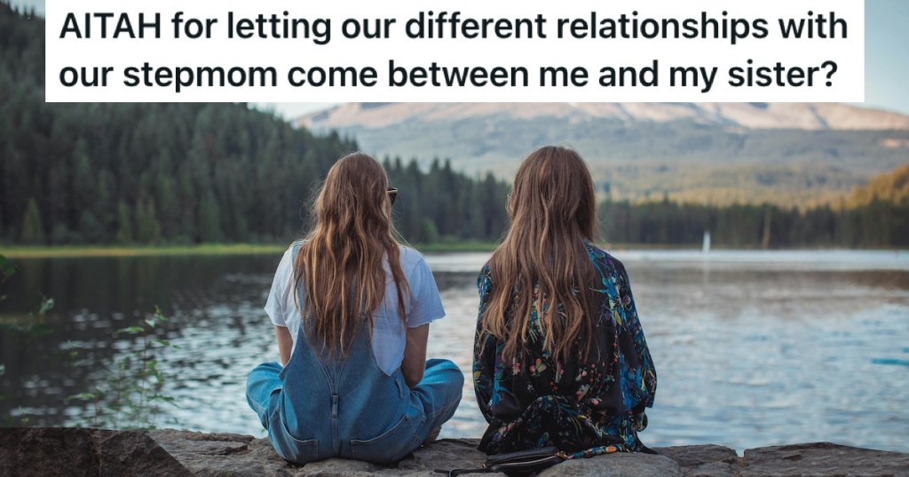Two women sitting on a wall overlooking a lake
