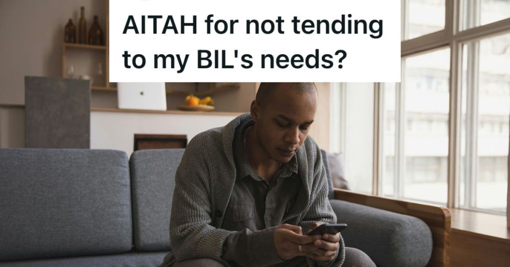 Man sitting on the couch looking at his phone