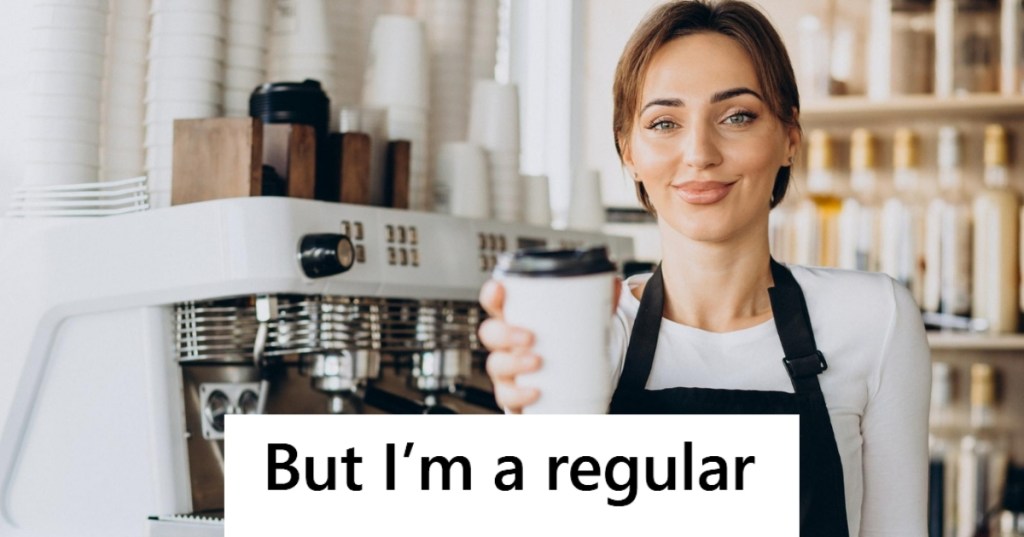 Woman barista holding coffee cup