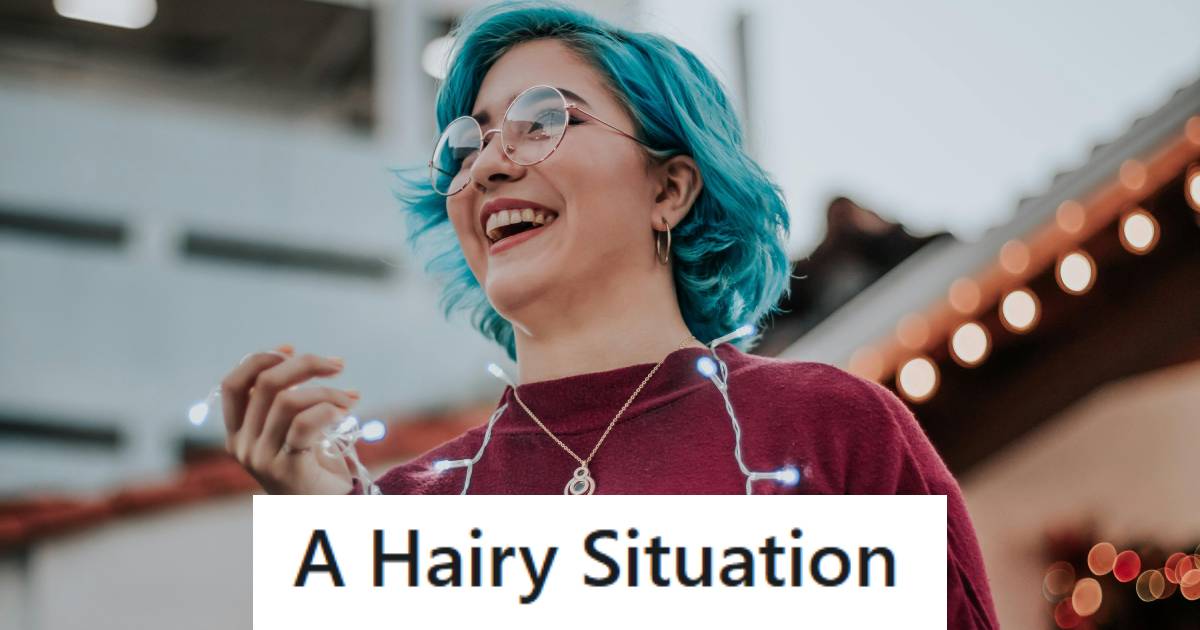 Woman with blue hair smiling and laughing with her friends