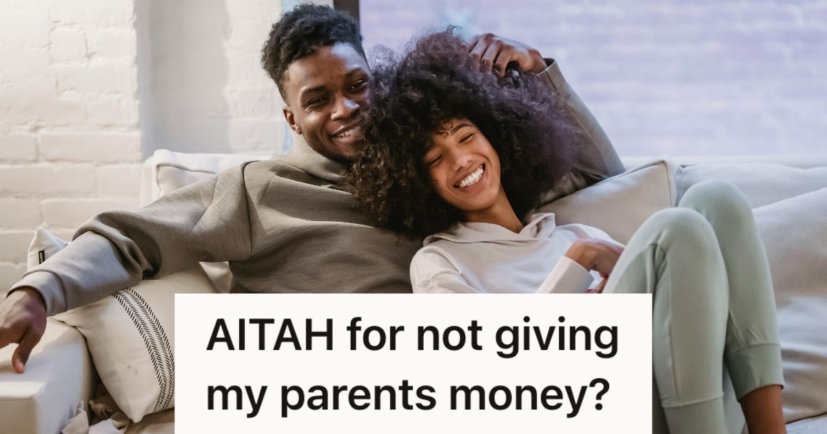 Young couple smiling and cuddling on couch