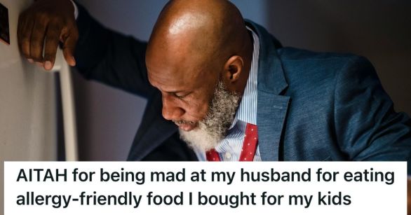 Man in suit looking in refrigerator