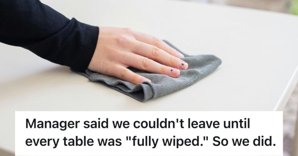 A hand wiping a table with a wash cloth