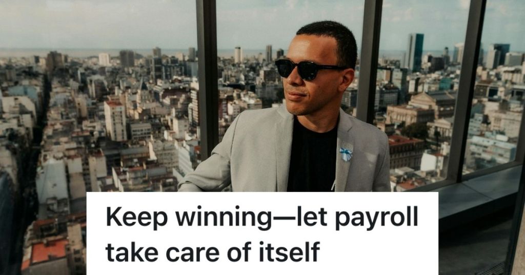 Young man smiling in front of office window