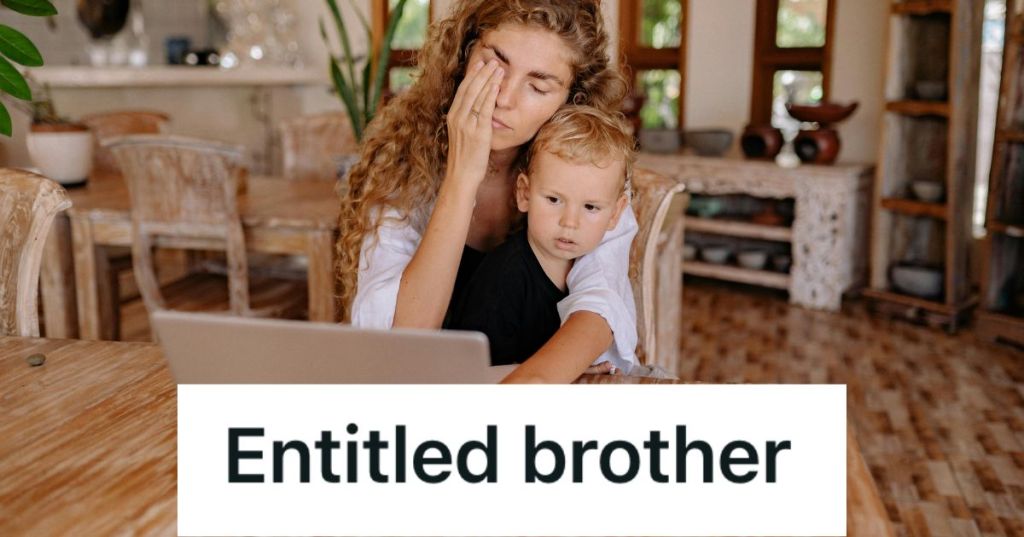 Tired mom in front of a laptop with a child on her lap