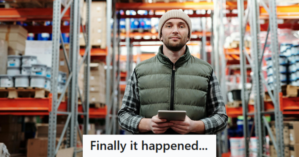 man in jacket standing in a warehouse