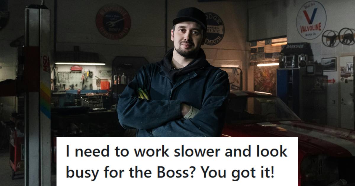 Mechanic smiling and posing for the camera because he has nothing better to do