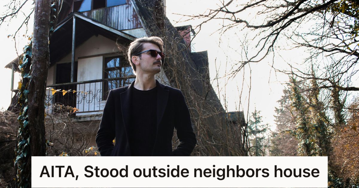 Man in black standing outside a house