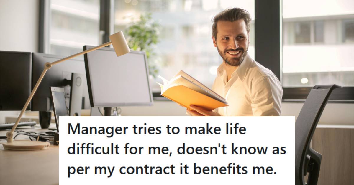 Man smiling at his desk because his manager got what she deserved