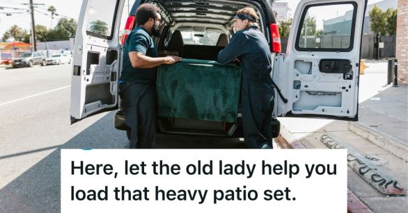 Two men loading a big box into a van