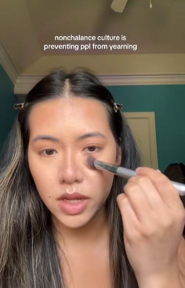 Woman talking and putting on makeup