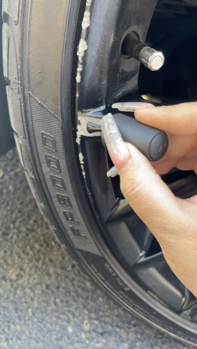 putting nail polish on a car