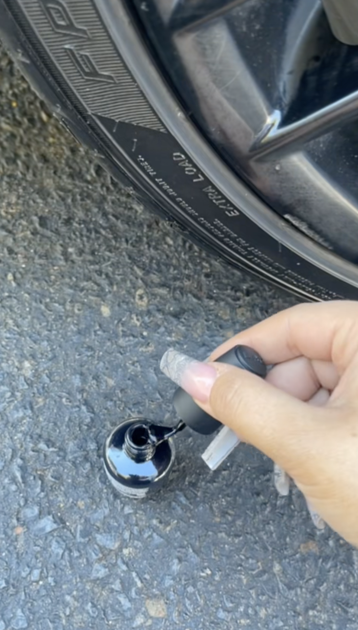 putting black nail polish on a car