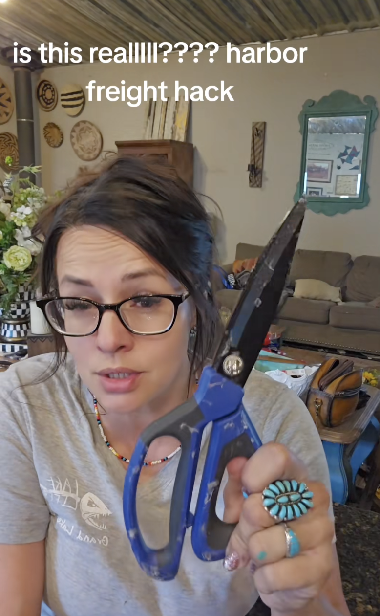 woman holding pair of scissors